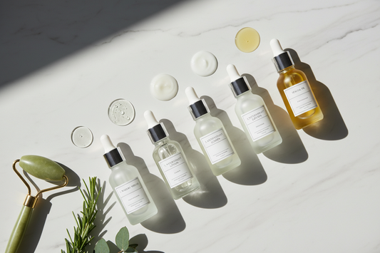 Skincare serum layering order showing different serum textures from watery to oil-based on marble surface - proper sequence for maximum absorption and results